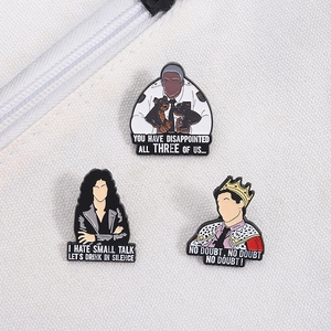 Close-up of three Brooklyn Nine-Nine enamel pins on a white textured canvas background