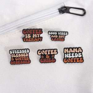 Detailed view of coffee series enamel pins pinned on white canvas bag side