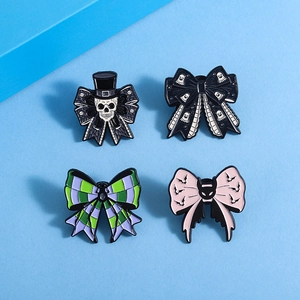 Detail view of 4-piece punk Halloween enamel pins with bowknots and spooky motifs