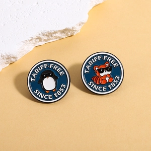 Cartoon animal enamel pins with penguin and fox wearing sunglasses on blue round badges
