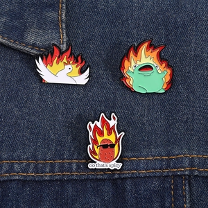 Creative cartoon fire animal enamel pin set featuring a goose and frog on denim