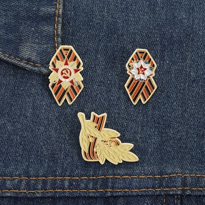 Macro detail of St. George ribbon pins and Soviet star badges on blue denim background