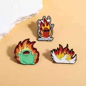 Cartoon enamel pin set with flaming frog, spicy potato and goose on beige background