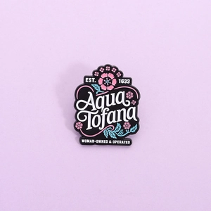Minimalist enamel flower brooch featuring Aqua Tofana lettering on light purple background