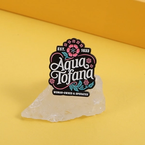 Cartoon plant flower enamel pin with Aqua Tofana text on yellow background