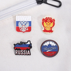 Detailed set of four Russian coat of arms enamel pins on a white canvas background