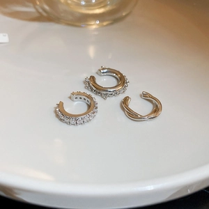 Three-piece silver cubic zirconia ear cuff set with chain and twisted metal designs