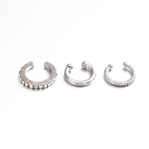 Three-piece silver ear cuff set featuring zircon crystals and minimalist metal textures