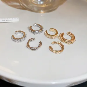 Elegant 6-piece zircon ear cuff set in gold and silver finish on a ceramic plate
