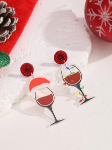 Detail of asymmetrical Christmas wine glass acrylic earrings with glitter studs