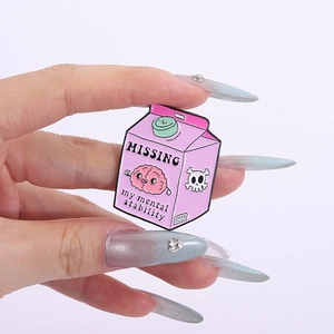 Detail of pink milk carton enamel pin with brain illustration and creative text
