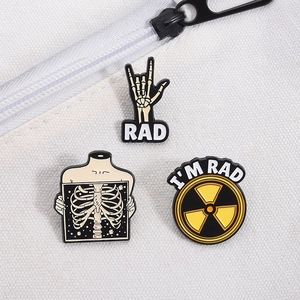 Détail de pins en émail main de squelette et rayons X sur un sac en toile blanc