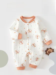 Detail of warm cotton baby bodysuit with soft quilted texture and cute bear prints