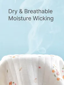 Breathable cotton newborn romper with orange prints showing air permeability feature