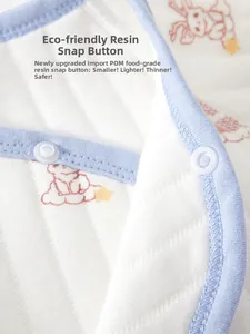 Detail of eco-friendly resin snap buttons on cotton newborn baby clothes with cartoon print