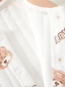 Detail of baby cotton jumpsuit featuring eco-friendly POM resin snaps and bear pattern