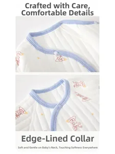 Detail of baby quilted cotton romper showing blue neckline trim and deer prints