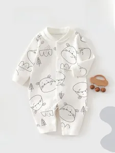 Close-up of baby romper featuring cartoon hippo print and metallic snap button closures