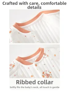 Close-up of quilted cotton baby romper neckline with snap buttons and bear patterns