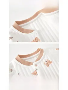 Detail of baby quilted cotton bodysuit showing ribbed neckline and brown bear print