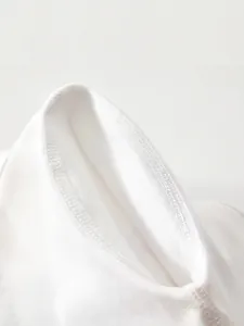 Seamless 4-needle 6-thread flatlock stitching on soft white cotton baby bodysuit