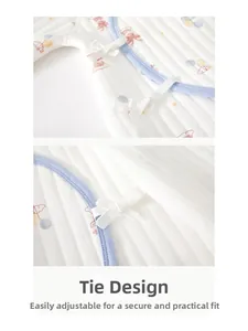 Detail of baby quilted cotton bodysuit with blue piping and adjustable tie-up closures