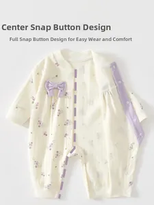 Detail view of baby romper featuring snap button design and purple grape pattern