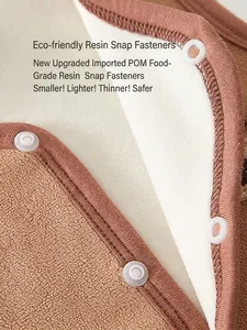 Fleece baby vest detail showing safe food-grade POM resin snap buttons on soft fabric