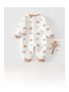 Close-up of quilted baby bodysuit with brown bear print and soft ribbed edges
