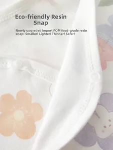 Detail of eco-friendly POM resin snaps on floral cotton baby romper for safety