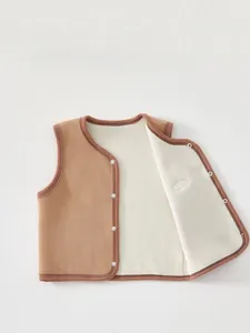 Detail of baby fleece vest showing soft khaki polar fleece fabric and button closure