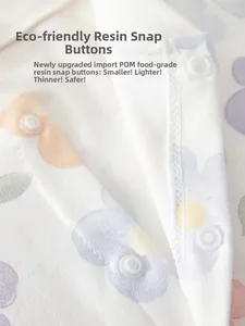 Detail of food-grade POM resin snap fasteners on floral cotton baby romper fabric
