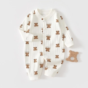 Detail of ribbed cotton baby romper featuring brown bear prints and snap button closure