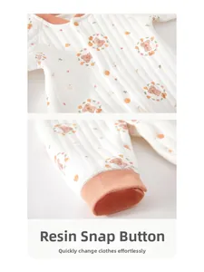 Detail of infant quilted cotton jumpsuit featuring resin snaps and brown bear print