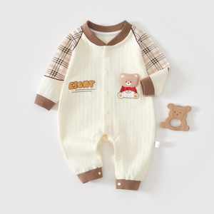 Detail of infant waffle cotton romper with bear applique and snap button closure