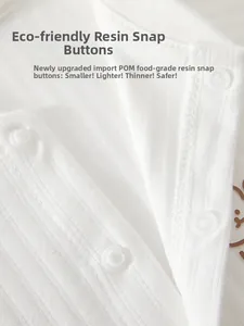 Close-up of baby bodysuit with safe POM food-grade resin snap buttons on cotton fabric