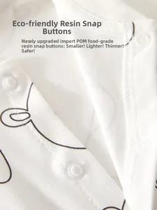 Detail of POM food-grade resin snaps on white cotton infant bodysuit with rabbit print