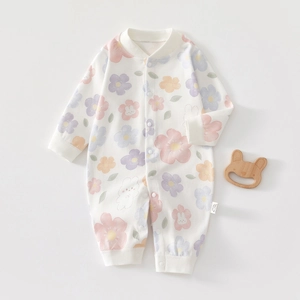 Detail of baby cotton romper featuring cartoon rabbit print and snap button closure