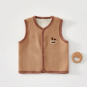Detail of fleece toddler vest featuring love embroidery and decorative lion toy