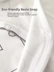 Detailed macro view of eco-friendly food-grade resin snaps on soft cotton baby romper
