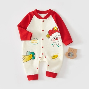 Detailed view of baby cotton romper with red sleeves and festive cartoon prints
