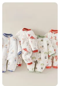 Detailed view of four colorful padded baby rompers with quilted fabric and snap buttons
