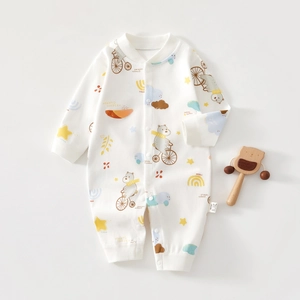 Detail of soft cotton baby romper with cartoon bear print and snap button closure