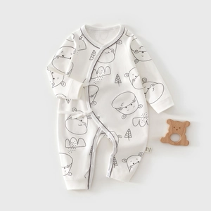 Detail of cotton baby romper with hippo print and side-tie buttons for easy dressing