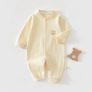 Close-up of baby romper fabric featuring bear embroidery and soft cotton rib knit texture