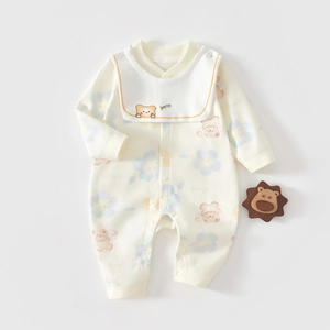 Detail of baby cotton romper with bear floral print and embroidered bib