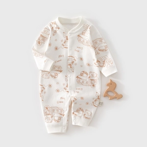 Detailed view of baby romper featuring brown bear prints and snap button closure