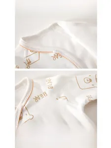 Close-up of cotton baby romper featuring a bear print with ribbed collar and shoulder snaps
