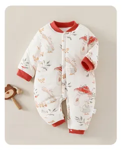 Detailed view of white baby winter romper with duck prints and red ribbed cuffs