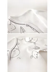 Close-up of soft cotton baby romper neckline with snap buttons and hippo print